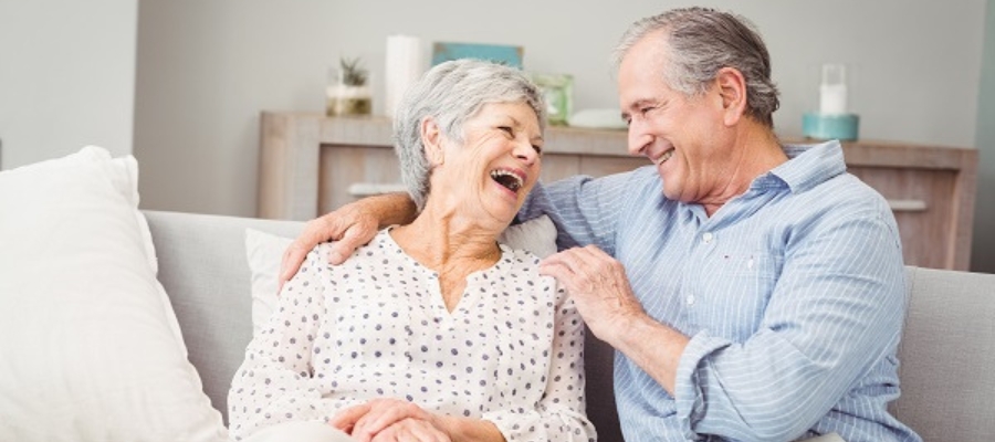 elderly couple sitting on couch